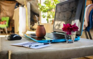 White Notebook Beside Blue Laptop Computer